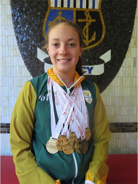 Kate Beavon shows off her numerous medals which she's achieved for swimming.